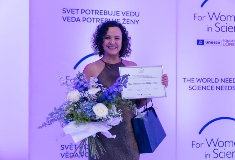A física Natália Salomé Móller posando com sua premiação do Prêmio L'Oréal-Unesco Para Mulheres na Ciência, na Eslováquia.